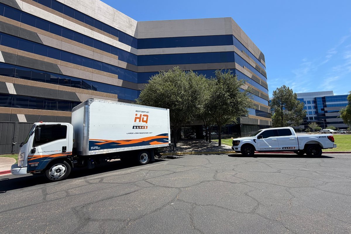 Restoration HQ large loss response truck and service vehicle parked outside a commercial office building